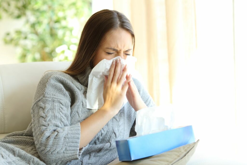 Woman blowing with flu in